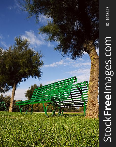 Two empty benches facing opposite directions. Two empty benches facing opposite directions