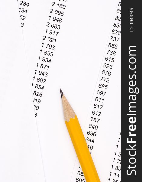 Yellow pencil on documents and numbers