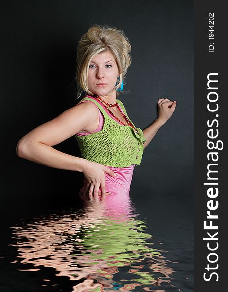 A beautiful girl posing in fashion poses and creative outfits with water reflections