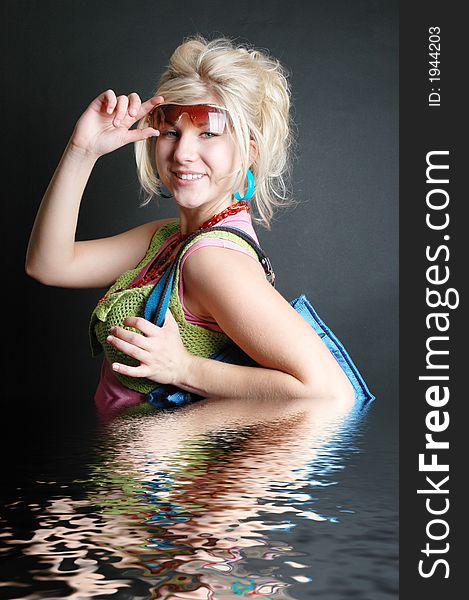 A beautiful girl posing in fashion poses and creative outfits with water reflections