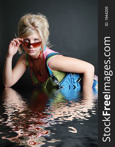 A beautiful girl posing in fashion poses and creative outfits with water reflections