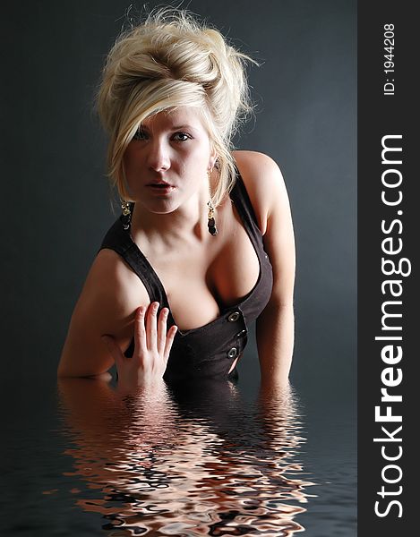 A beautiful girl posing in fashion poses and creative outfits with water reflections