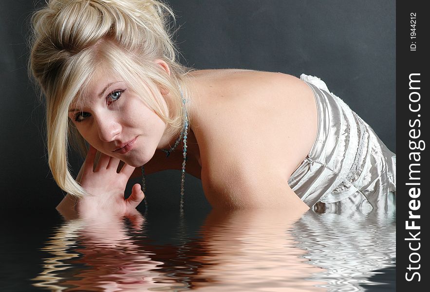 A beautiful girl posing in fashion poses and creative outfits with water reflections