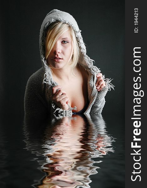 A beautiful girl posing in fashion poses and creative outfits with water reflections