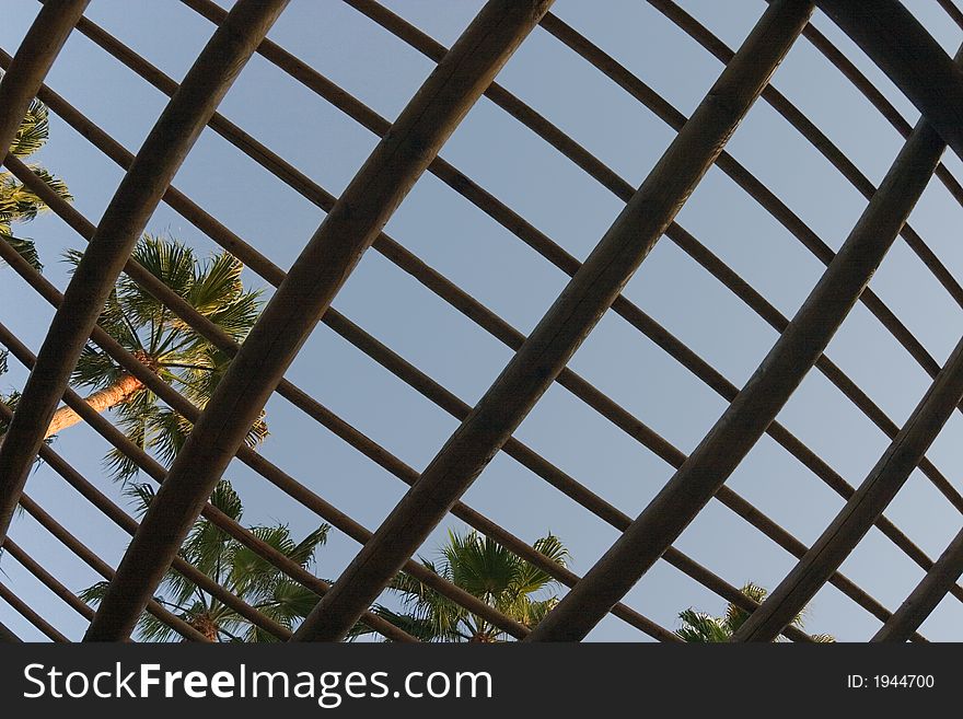 Trellised roof against a background of the blue sky. Trellised roof against a background of the blue sky