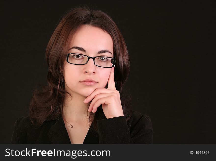 Business woman thinking and giving an idea to a problem, black background