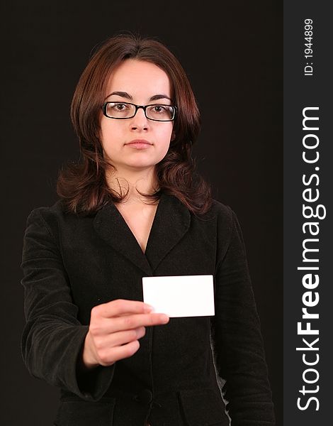 Business woman showing a blank business card to you, black background