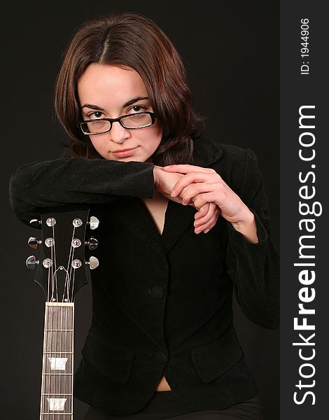 Business woman with a luxury electric guitar, abstract concept for showbiz, black background