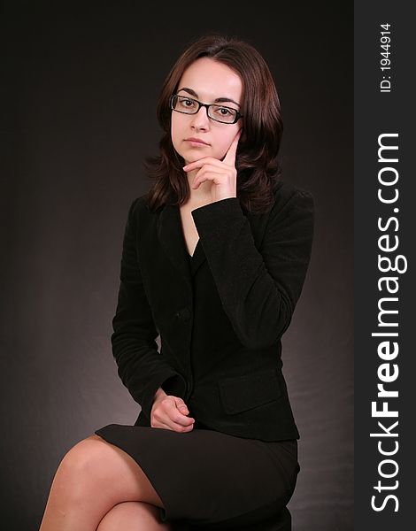 Business woman thinking and giving an idea to a problem, black background