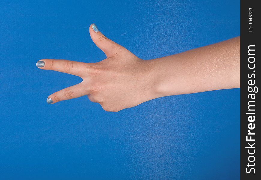 Figure of fingers with blue nacre manicure against blue background. Figure of fingers with blue nacre manicure against blue background