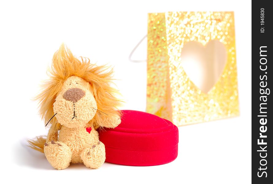 Little stuffed lion with small gift box and bag over white background. Little stuffed lion with small gift box and bag over white background