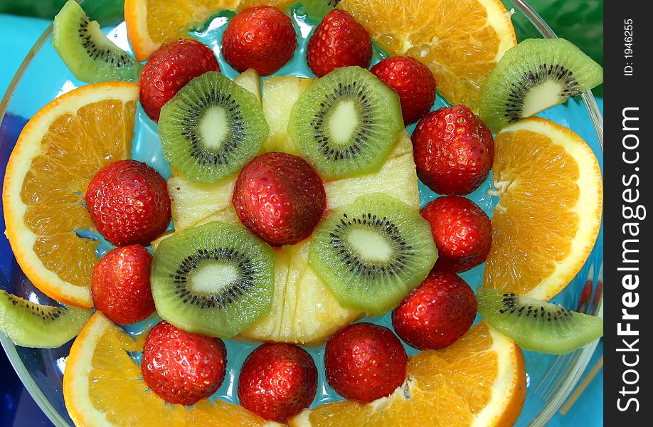 Orange, strawberries, kiwi and other fruits in a salad. Orange, strawberries, kiwi and other fruits in a salad