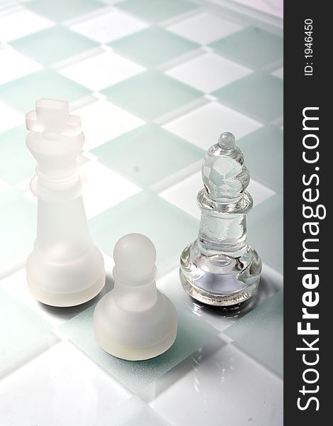 High key Glass Chess Pieces on a sandblasted glass chess board