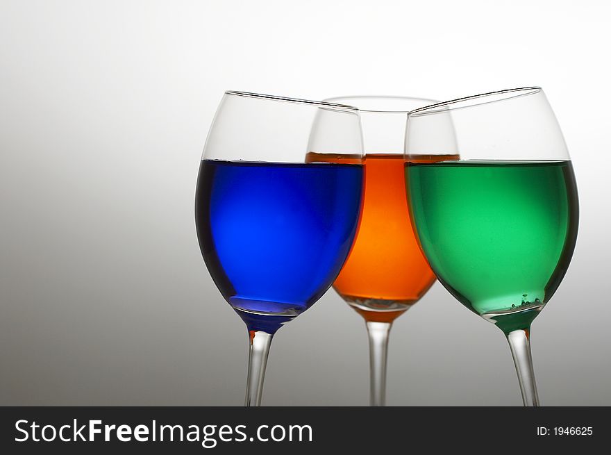 Wine glasses with three colors of drink