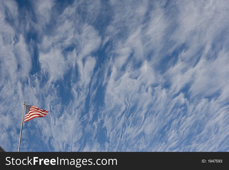 A torn american flag flies beneath dramatic winter clouds. (those were the clouds - this image has not been manipulated). A torn american flag flies beneath dramatic winter clouds. (those were the clouds - this image has not been manipulated)