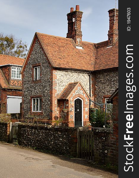 Quaint Brick and Flint Cottages on a Village Road in England