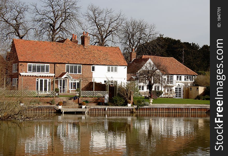 House with Boat Moorings on the banks of a River in England. House with Boat Moorings on the banks of a River in England