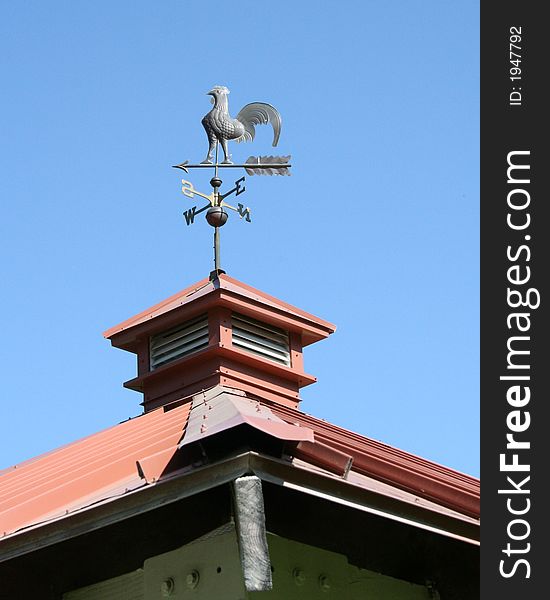 A weather vane on top of a local structure