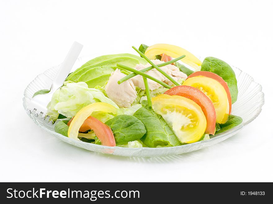 Lettuce and spinach combined to form a bed for sliced avocado, red and yellow tomatoes, with tuna on top. Lettuce and spinach combined to form a bed for sliced avocado, red and yellow tomatoes, with tuna on top.