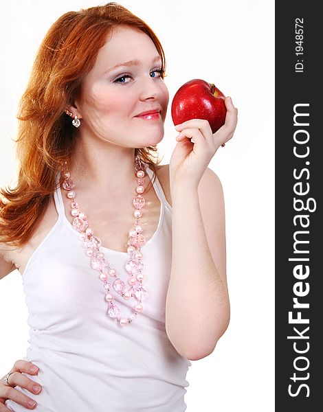 Young beautiful sexy red smiling woman with apple on the white background. Young beautiful sexy red smiling woman with apple on the white background
