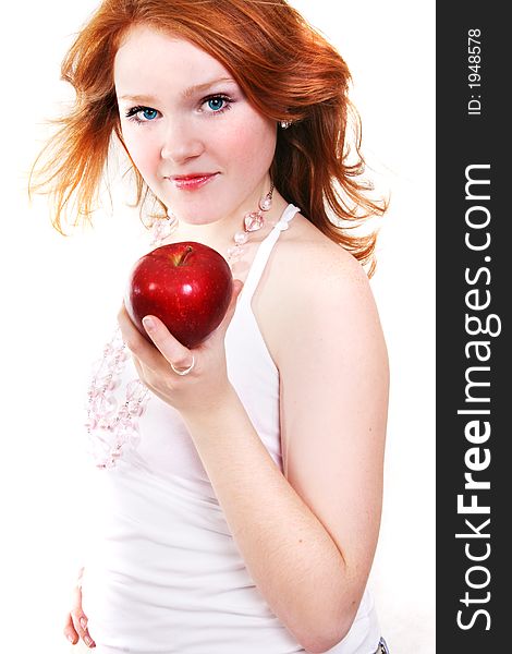 Young beautiful red smiling woman with apple on the white background. Young beautiful red smiling woman with apple on the white background