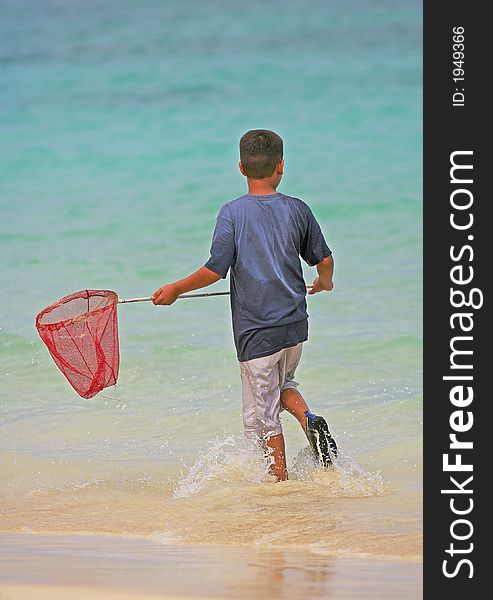 Photo of Hawaiian boy fishing at the beach. Photo of Hawaiian boy fishing at the beach