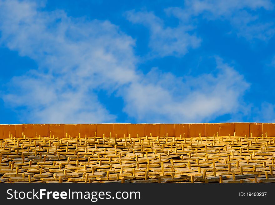 Pegged wooden shingles under wispy cloud blue sky. Pegged wooden shingles under wispy cloud blue sky