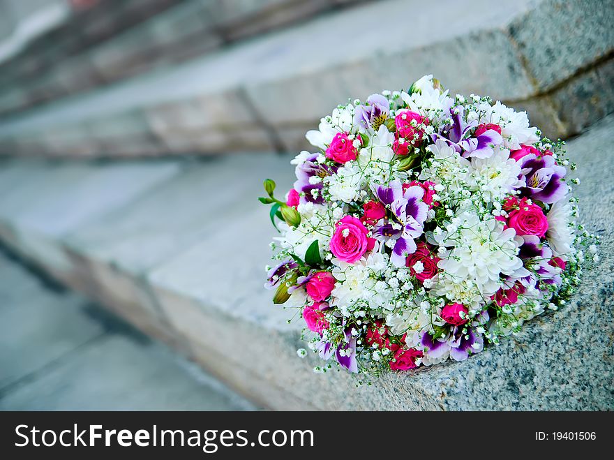 Bridal bouquet on the stone stairs. Bridal bouquet on the stone stairs