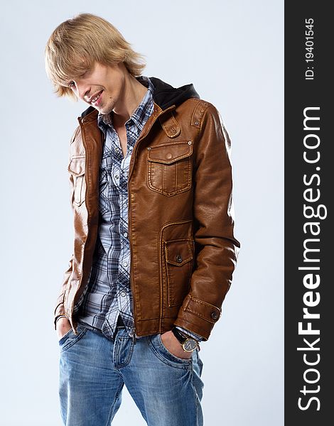 Handsome young man in leather jacket, studio portrait