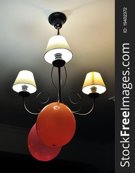 Two balloons and a lamp on a party day