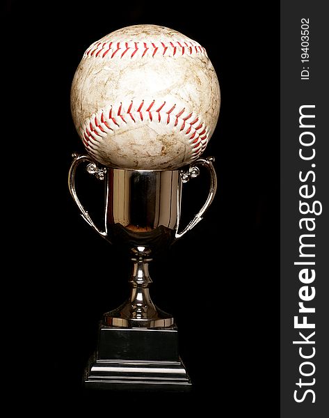 Trophy and softball isolated on black