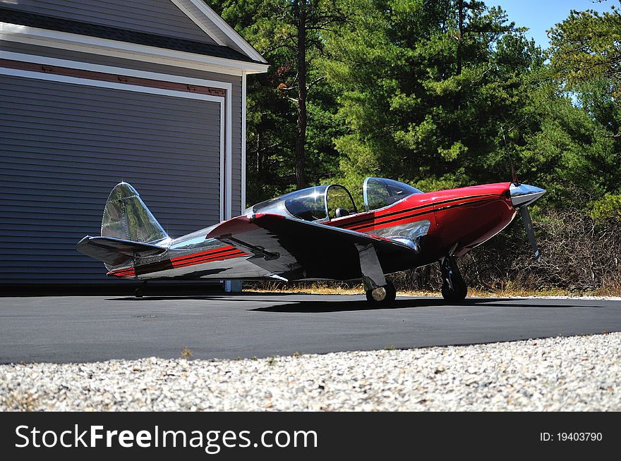 Vintage airplane in front of a hanger