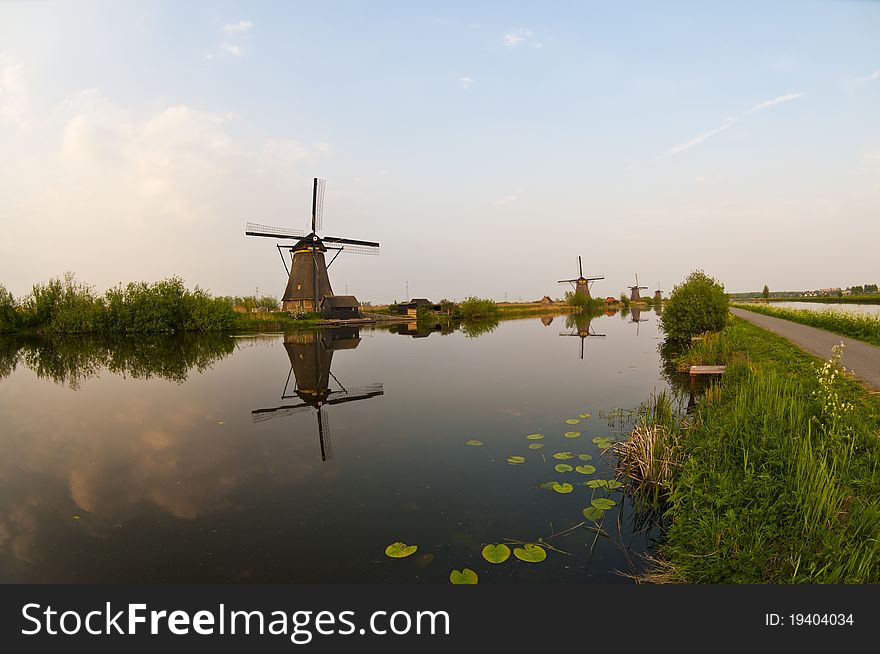 Windmills in the evening sunset after the rain. Windmills in the evening sunset after the rain.