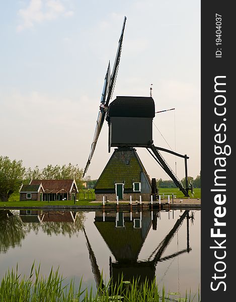 A windmill in the evening sunset after the rain. A windmill in the evening sunset after the rain.