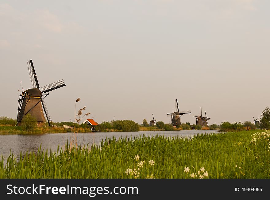 Windmills in the evening sunset after the rain. Windmills in the evening sunset after the rain.