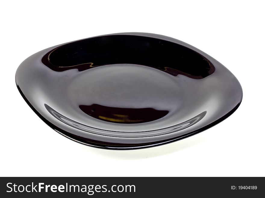 Plate from dark glass on a white background