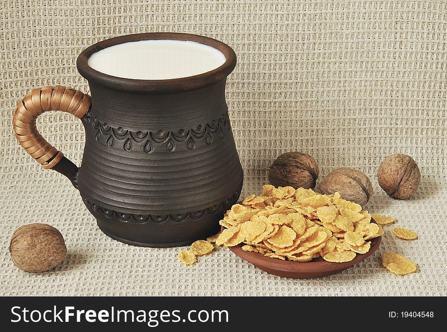 Milk  milk in a ceramic cup,corn-flakes and nuts. Milk  milk in a ceramic cup,corn-flakes and nuts