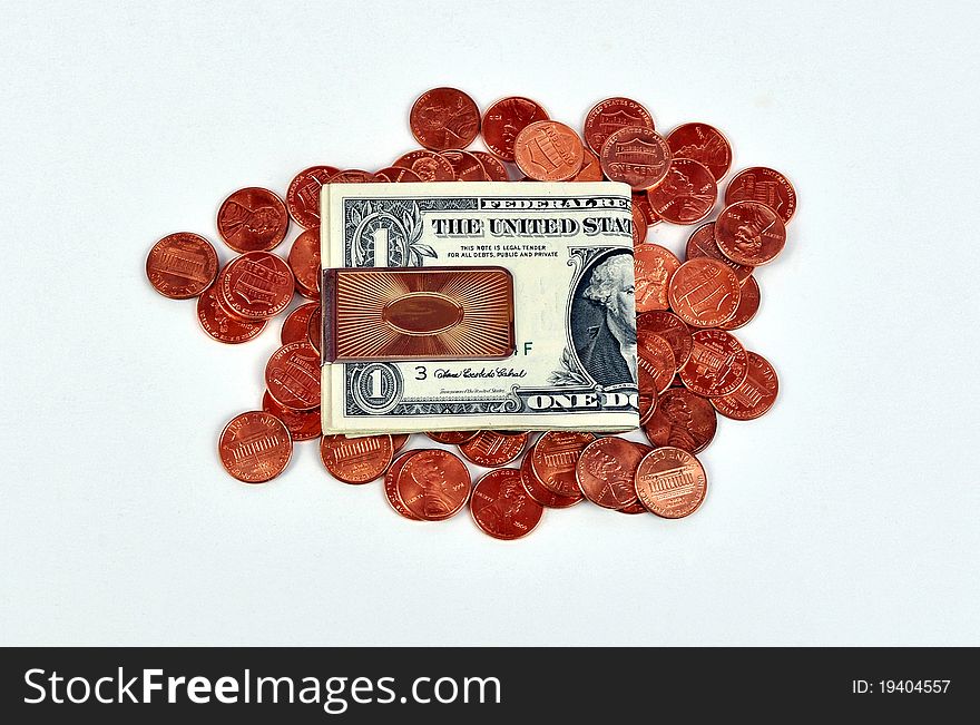 Dollar bills in gold money clip on new pennies. Dollar bills in gold money clip on new pennies