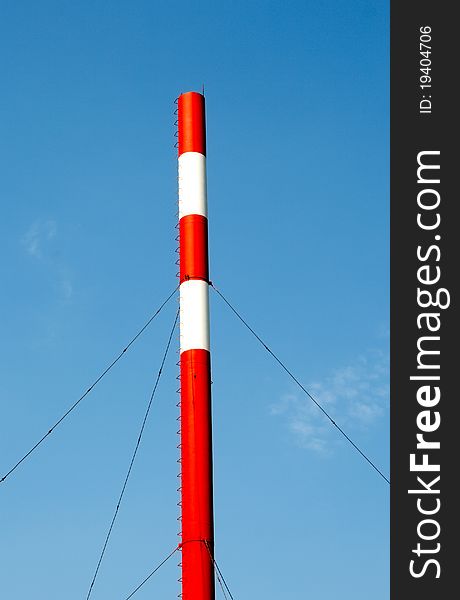 The factory pipe against the blue sky. The factory pipe against the blue sky.