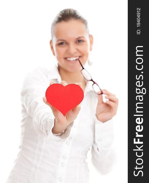 Lovely young woman offering a red heart to us, over white background. Lovely young woman offering a red heart to us, over white background