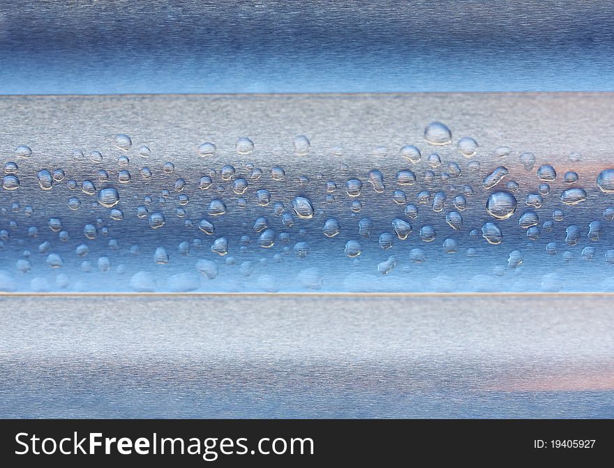 Abstract composition of waterdrops over metal surface, copy space