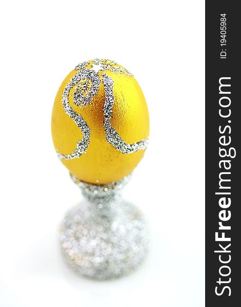 Golden egg over silver stend