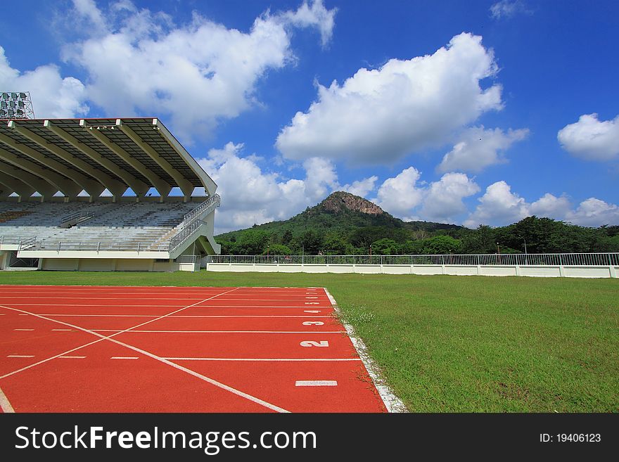 A red running track with blue sky