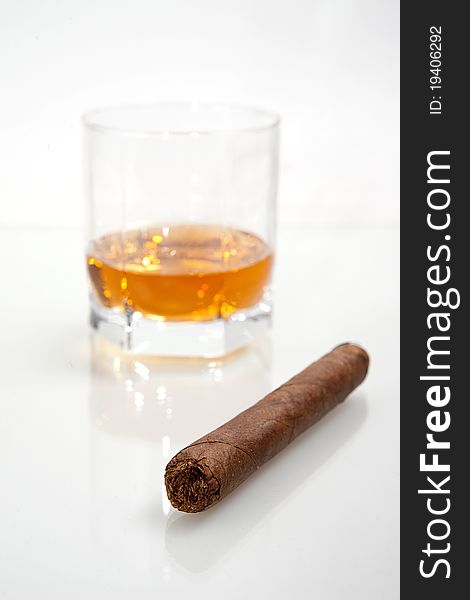 A cigar and a glass of brandy. A cigar and a glass of brandy.