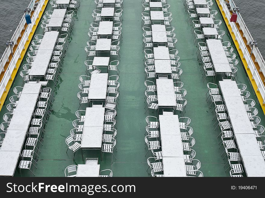 Dining aboard. a boat along a long dining table on a boat on a river.