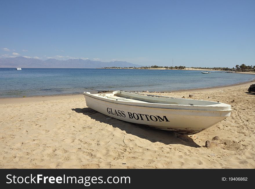 Tourist boat for coral watching on Red Sea sandy beach. Tourist boat for coral watching on Red Sea sandy beach.