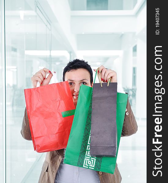 Modern woman shopping in mall holding bags