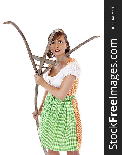 Beautiful young Bavarian woman with dirndl attacks with pitchfork.Isolated on white background. Beautiful young Bavarian woman with dirndl attacks with pitchfork.Isolated on white background.