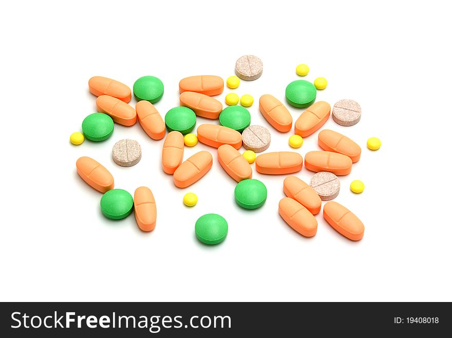 A lot of colourful bright pills on white background. A lot of colourful bright pills on white background