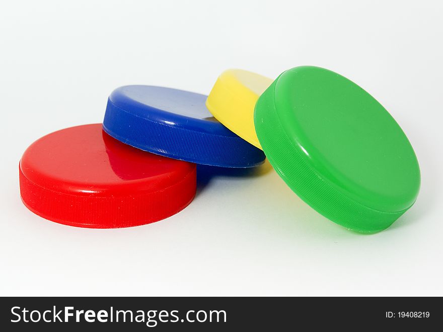 Color caps on white background with blue, red, green, yelow caps